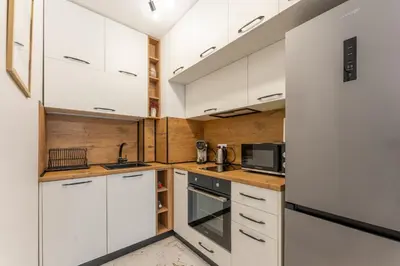 a kitchen with white cabinets and a microwave at Bright and Cozy Apartment at a quiet Location in Sofia