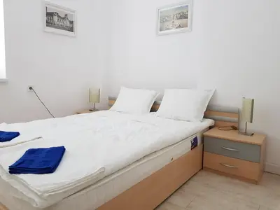 a bedroom with a large white bed with two lamps at Moder and Old Top in Sofia