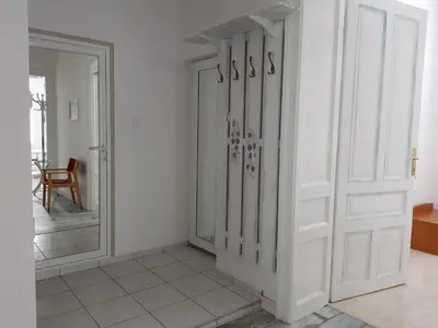 a white room with a door and a mirror at Moder and Old Top in Sofia
