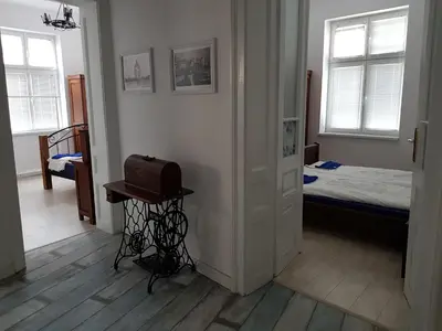a room with a bedroom with a bed and a table at Moder and Old Top in Sofia
