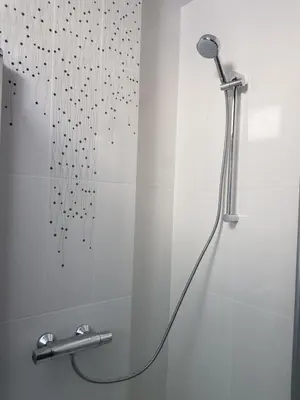 a shower with a shower head in a bathroom at Moder and Old Top in Sofia