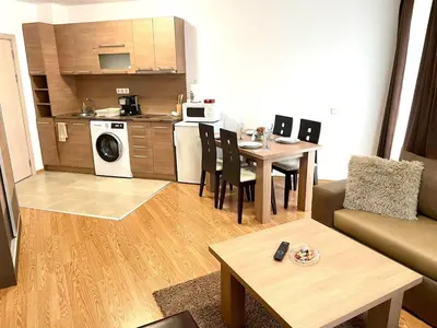a living room with a kitchen and a dining room at Steps from Gondola Private Underground Parking by SI Stay in Bansko