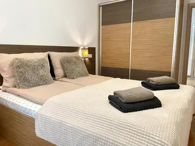two towels are sitting on top of a bed at Steps from Gondola Private Underground Parking by SI Stay in Bansko