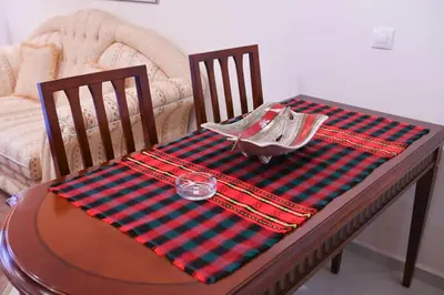 a table with a red and green checkered table cloth at Riverside 1BR in Downtown Near Ski Lift by Flat Mаnаger in Bansko