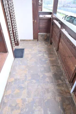 an empty porch with a door and a tiled floor at Riverside 1BR in Downtown Near Ski Lift by Flat Mаnаger in Bansko