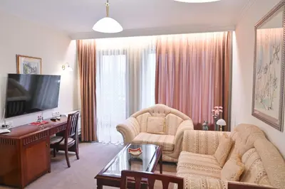 a living room with a couch and a table at Riverside 1BR in Downtown Near Ski Lift by Flat Mаnаger in Bansko