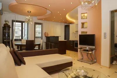a living room with a couch and a television at South Park Cozy Flat in Sofia