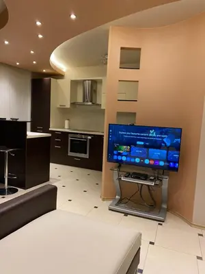 a living room with a large flat screen tv on a wall at South Park Cozy Flat in Sofia