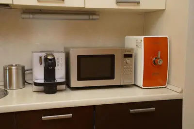 a microwave and other appliances on a counter in a kitchen at South Park Cozy Flat in Sofia