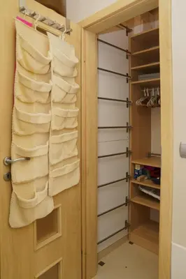 a closet with white towels hanging on a door at South Park Cozy Flat in Sofia