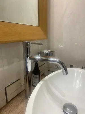 a bathroom with a white sink and a mirror at South Park Cozy Flat in Sofia