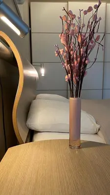 a vase with flowers sitting on a table at South Park Cozy Flat in Sofia