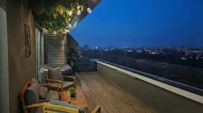 a balcony with a view of a city at night at ApArt by the river in Plovdiv