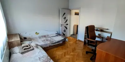 a room with two beds and a desk and a chair at violet's dream in Plovdiv