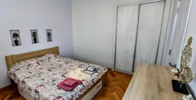 a bedroom with a bed and a wooden table at violet's dream in Plovdiv