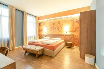 a bedroom with a bed and a wall with a poster at 1 BR Wine Journey in Sofia