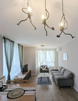 a living room with a couch and chandeliers at Olive Urban Apartment, Free Parking in Sofia
