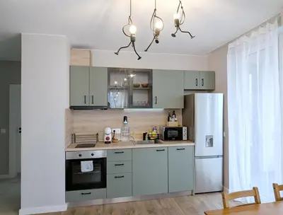 a kitchen with white cabinets and a refrigerator at Olive Urban Apartment, Free Parking in Sofia