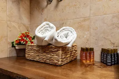 two baskets with towels on a counter with flowers at Vacation Home in Starosel Resort in Starosel
