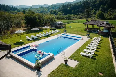 an overhead view of a swimming pool with lounge chairs at Къща за гости Бели Осъм in Beli Osŭm