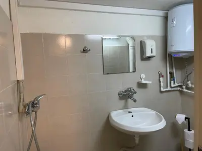 a bathroom with a sink and a mirror at Social Apartment in Sofia