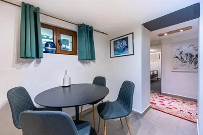 a dining room with a table and chairs at Social Apartment in Sofia