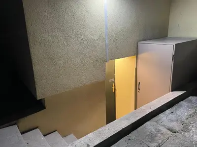 a metal refrigerator sitting on the side of a building at Social Apartment in Sofia