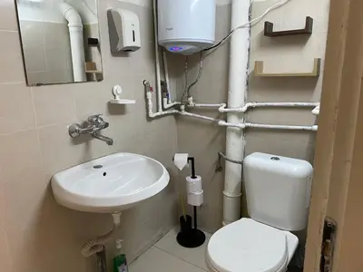 a small bathroom with a toilet and a sink at Social Apartment in Sofia