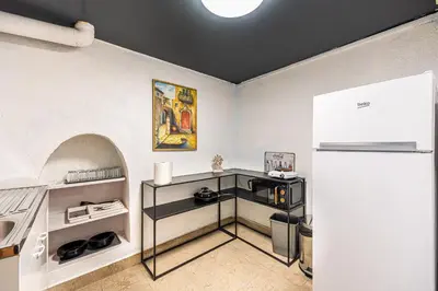 a kitchen with a counter top and a refrigerator at Social Apartment in Sofia