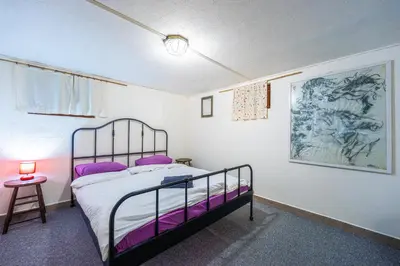 a bedroom with a bed with purple pillows at Social Apartment in Sofia