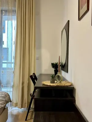 a dining room with a table and a mirror at Ski Apartment Bansko Home2Host in Bansko