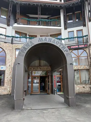 an entrance to a building with a sign that readsauntedauntedauntedauntedemetery at Grand Monastery apt Emo Pamporovo in Smolyan