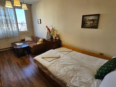 a bedroom with a bed and a living room at Affordable 3BR near Centre in Sofia