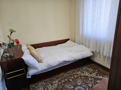 a small bed in a room with a window at Affordable 3BR near Centre in Sofia