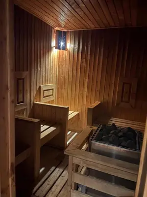 an empty wooden sauna with a bed in it at Chamkoria Borovets luxury apartment view in Borovets