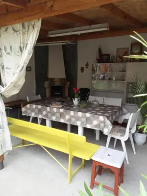 a dining room with a yellow table and chairs at Stai Za Gosti Venera in Hisarya
