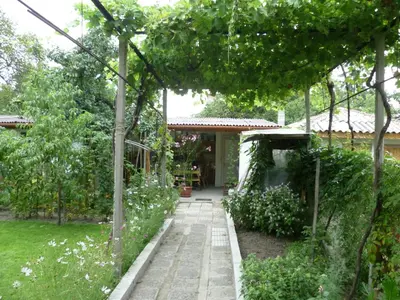 a garden with a pathway leading to a house at Stai Za Gosti Venera in Hisarya