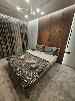 a bedroom with a large bed with two pillows on it at Luxury Forest Apartment in Borovets