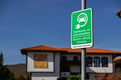 a green parking sign in front of a house at Vacation Apartment in Starosel complex in Starosel