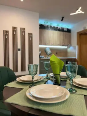 a table with plates and wine glasses on it at ViVa SPA Retreat in Velingrad