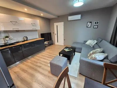 a living room with a couch and a kitchen at SUPERsonicondo 4 in Plovdiv