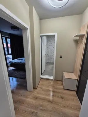 a hallway with a mirror and a bed in a room at SUPERsonicondo 4 in Plovdiv