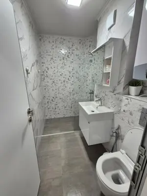a bathroom with a toilet and a sink at SUPERsonicondo 4 in Plovdiv