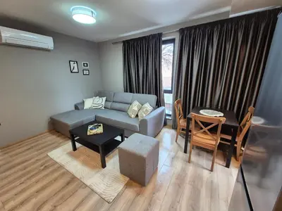 a living room with a couch and a table at SUPERsonicondo 4 in Plovdiv