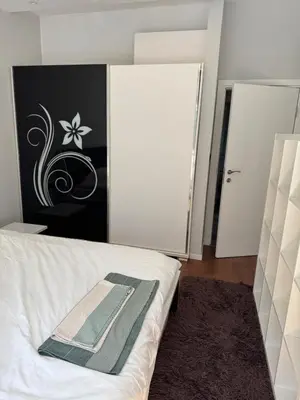 a bedroom with a bed with a black and white wall at Central Elegance NDK 3BDR in Sofia