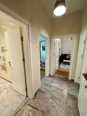 a hallway with white doors and a room at Central Elegance NDK 3BDR in Sofia