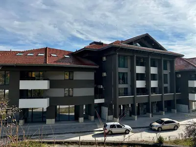 two cars parked in front of a building at Thermal Bliss Apartment in Velingrad