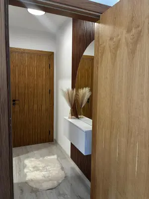 a bathroom with a sink and a wooden door at Thermal Bliss Apartment in Velingrad