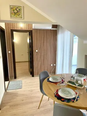 a dining room with a wooden table and chairs at 1BR Apartment Near Gondola by SI Stay in Bansko