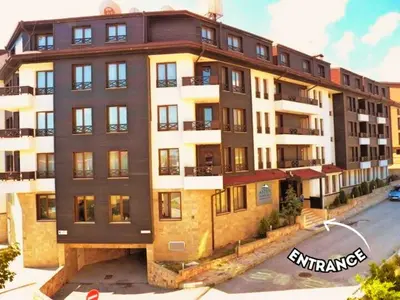 a large apartment building with a lot of windows at 1BR Apartment Near Gondola by SI Stay in Bansko